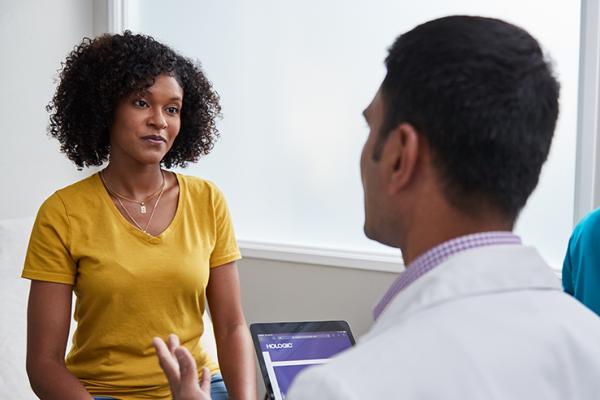 Woman in conversation with a doctor at a medical facility