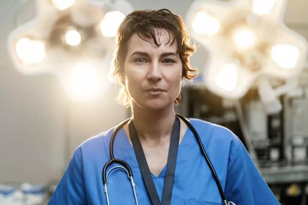 Surgeon looking into camera in an operating theatre