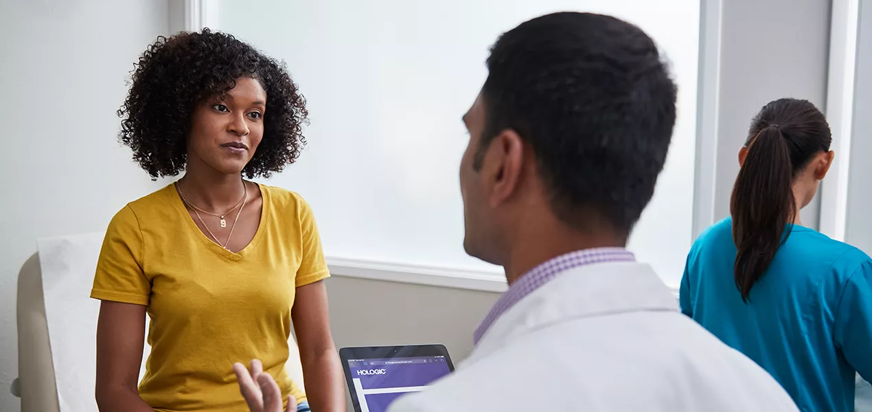 Woman in conversation with a doctor at a medical facility