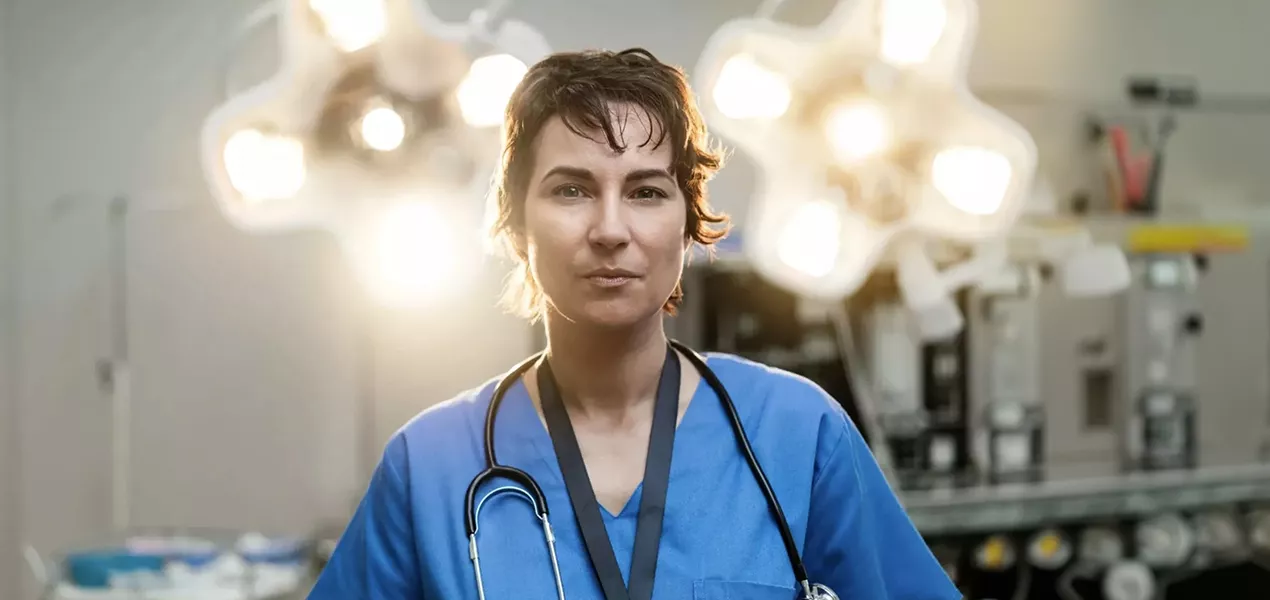 Surgeon looking into camera in an operating theatre